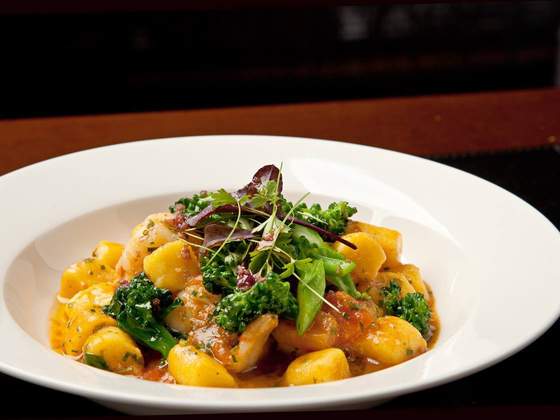 Gnocchi de mandioquinha com camarões, brócolis e jamón crocante